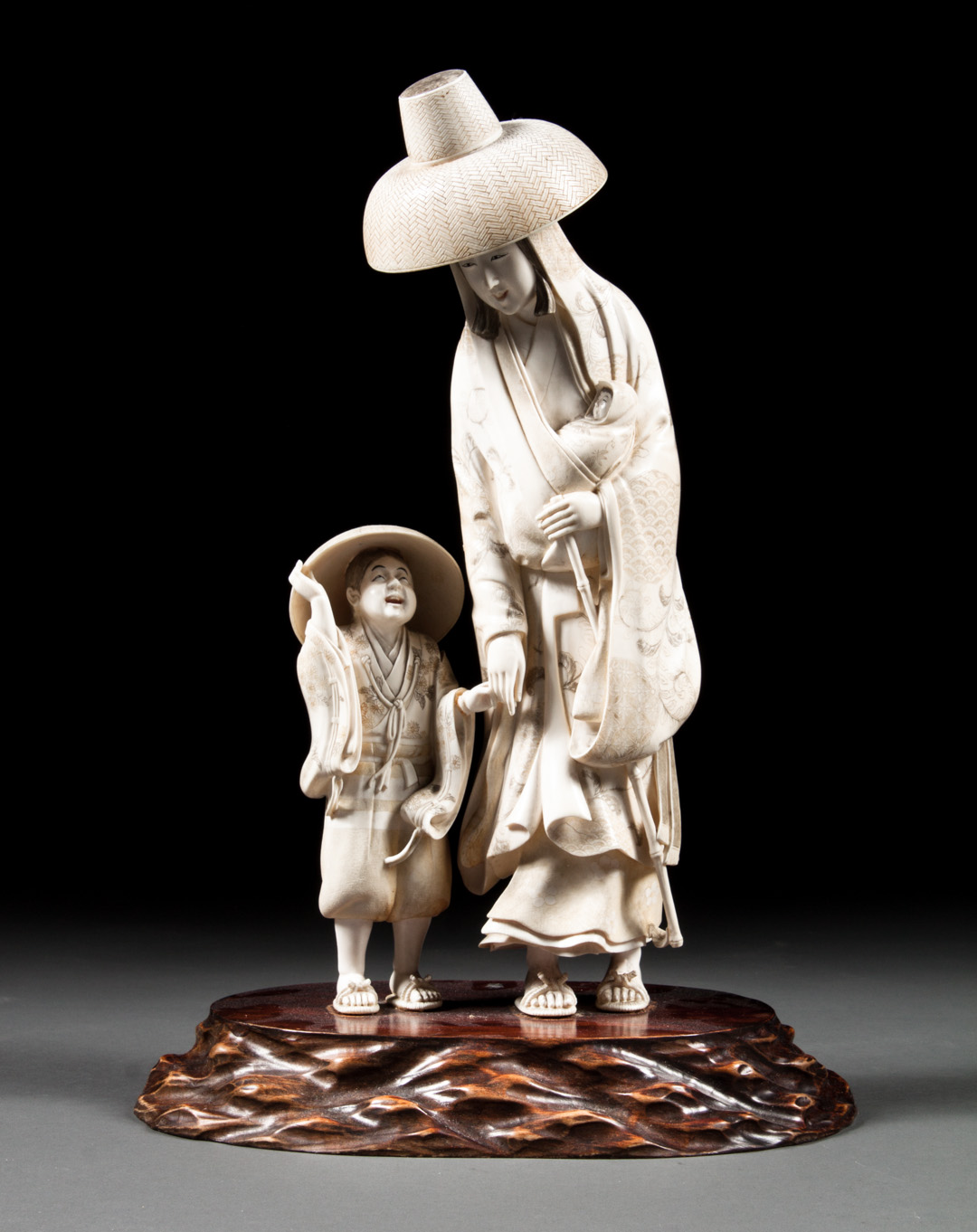 Appraisal: Japanese carved ivory family group late th century modeled as