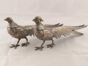 Appraisal: A pair of silver plated pheasants length cm