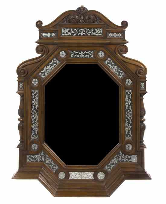 Appraisal: A Continental Mahogany Mirror having an elongated octagonal beveled plate