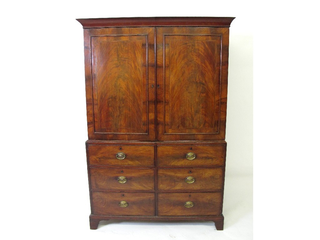 Appraisal: A th century mahogany inlaid linen press with two panelled