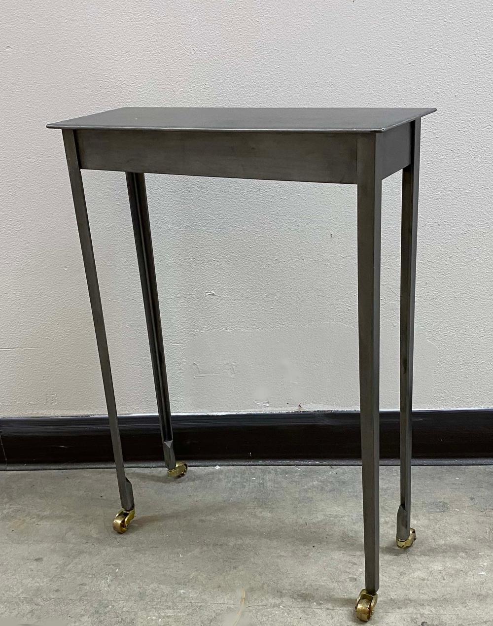 Appraisal: CONTEMPORARY POLISHED METAL SIDE TABLERectangular on straight tapered legs ending