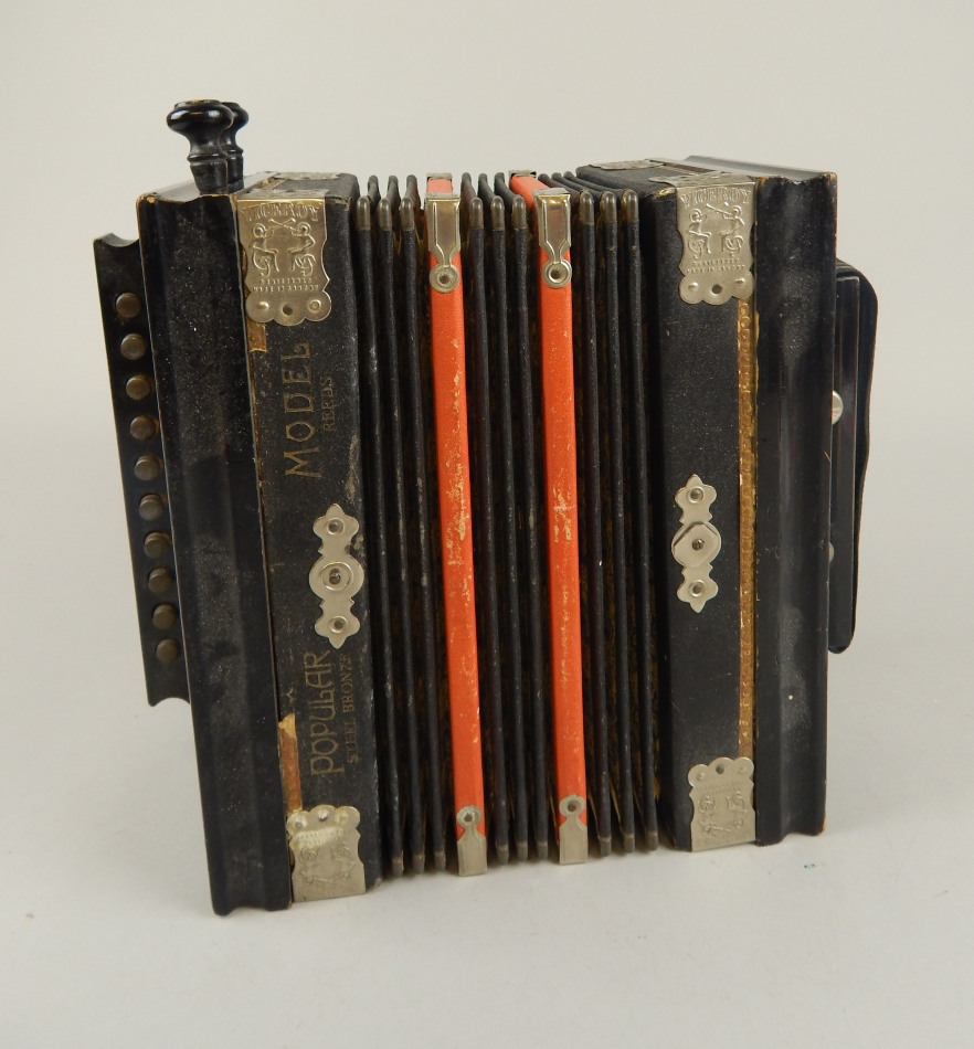 Appraisal: An early thC Popular squeeze box accordion ebonised with a