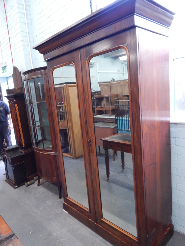 Appraisal: A Victorian mahogany wardrobe with two mirrored doors enclosing fitted