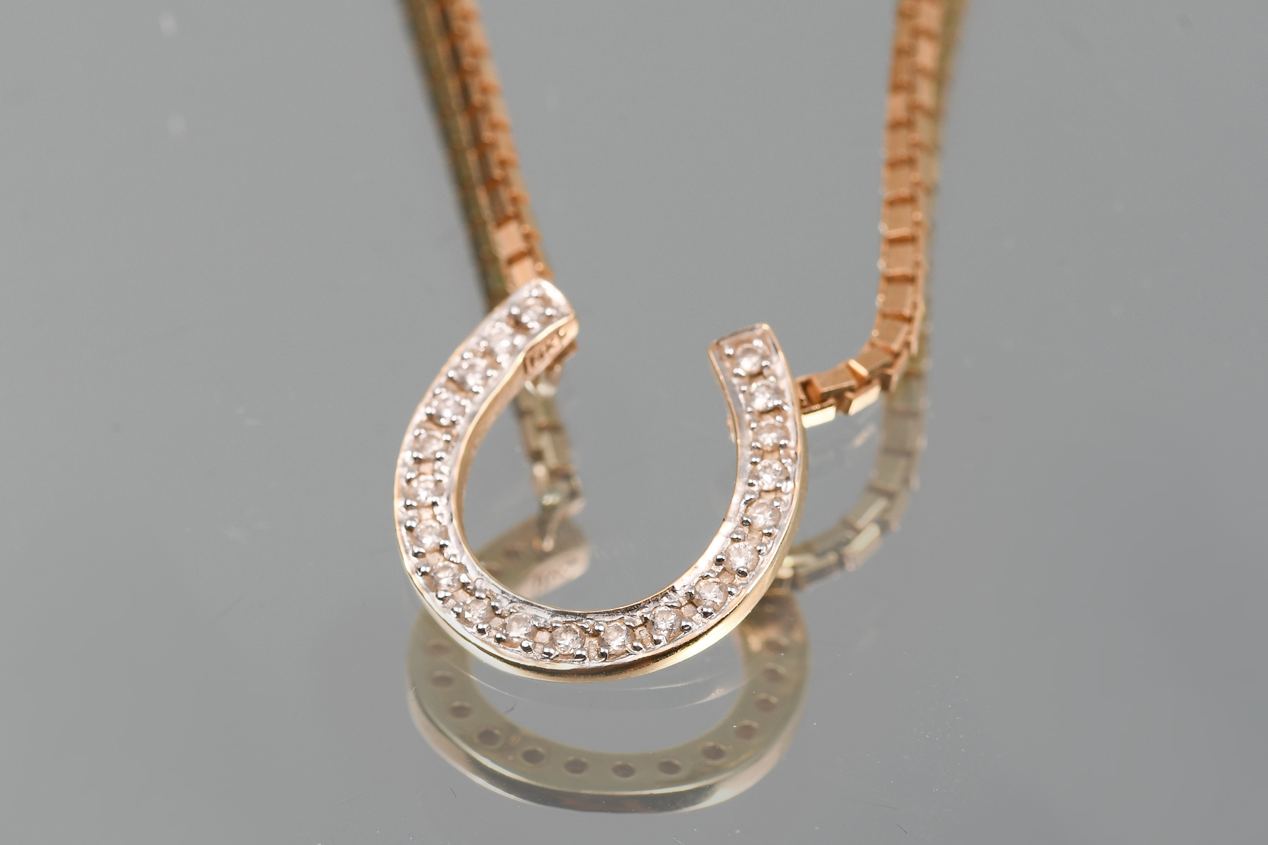 Appraisal: K CTW DIAMOND HORSESHOE NECKLACE K yellow gold horseshoe necklace