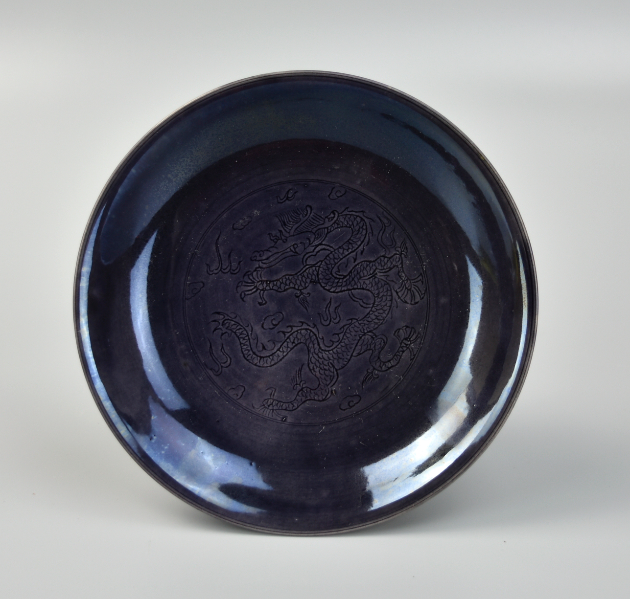 Appraisal: the dish covered overall in a purple glaze the center