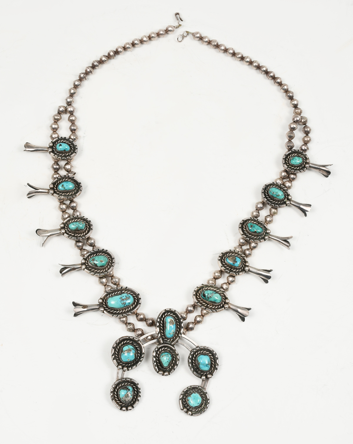 Appraisal: NATIVE AMERICAN TURQUOISE STERLING SQUASH BLOSSOM NECKLACE carinated sterling pieces