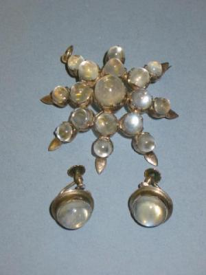 Appraisal: A MOONSTONE PENDANT BROOCH modelled as a star and set