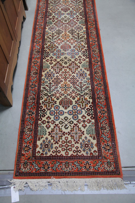 Appraisal: ORIENTAL STYLE RUNNER Orange and cream field with triple border