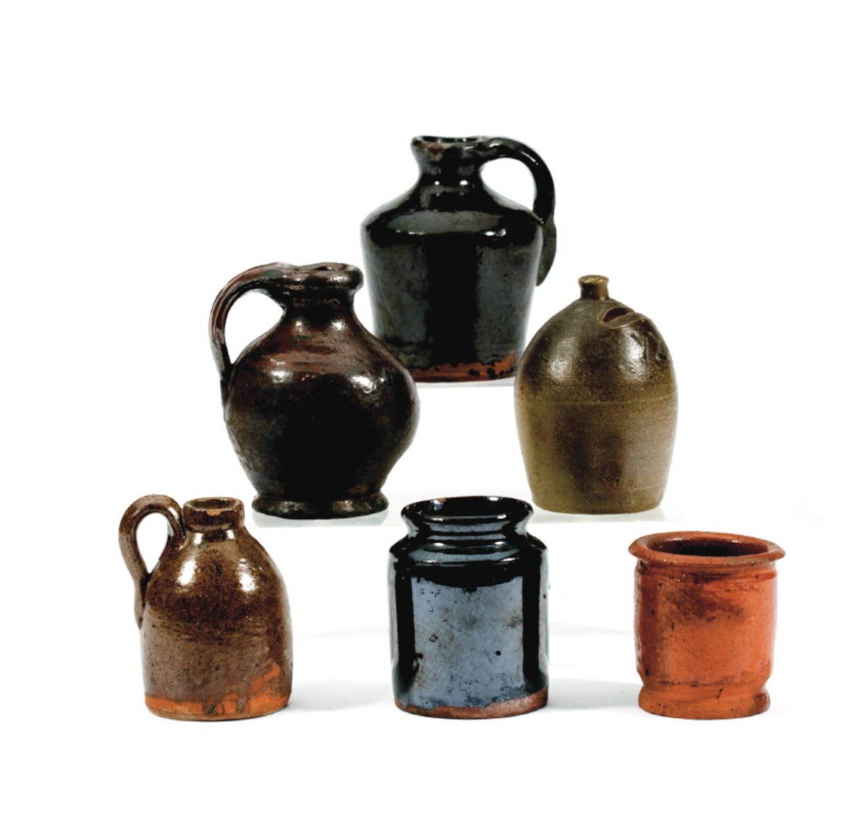 Appraisal: THREE GLAZED REDWARE AND STONEWARE MINIATURE JUGS A JUG-FORM BANK