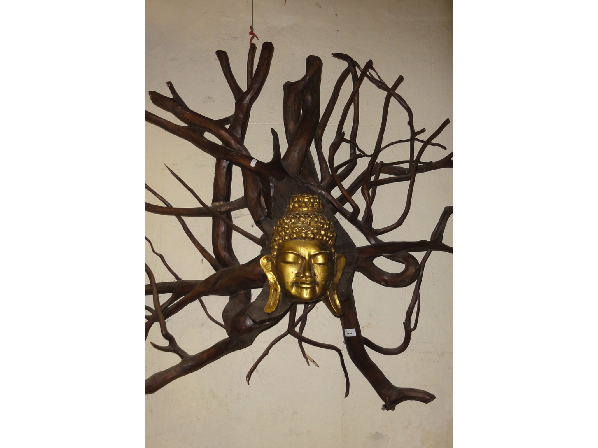 Appraisal: A decorative wall hanging root carving with central gilded Tai