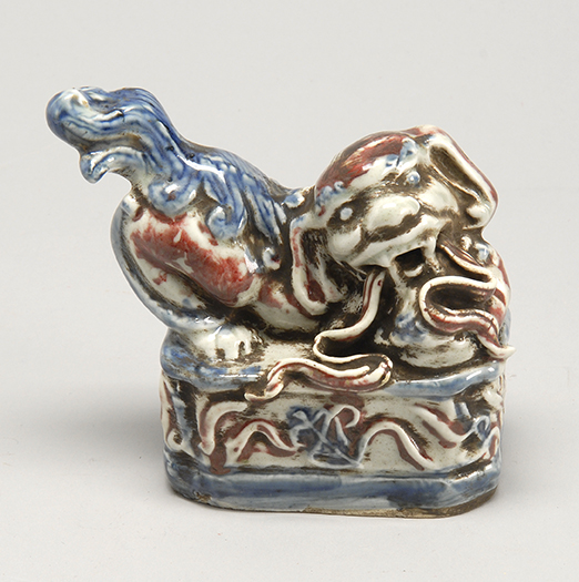 Appraisal: UNDERGLAZE RED AND BLUE PORCELAIN FIGURE Circa In the form