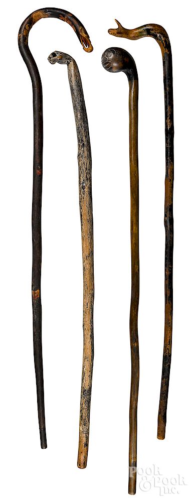 Appraisal: Four carved walking sticks late th c Four carved walking