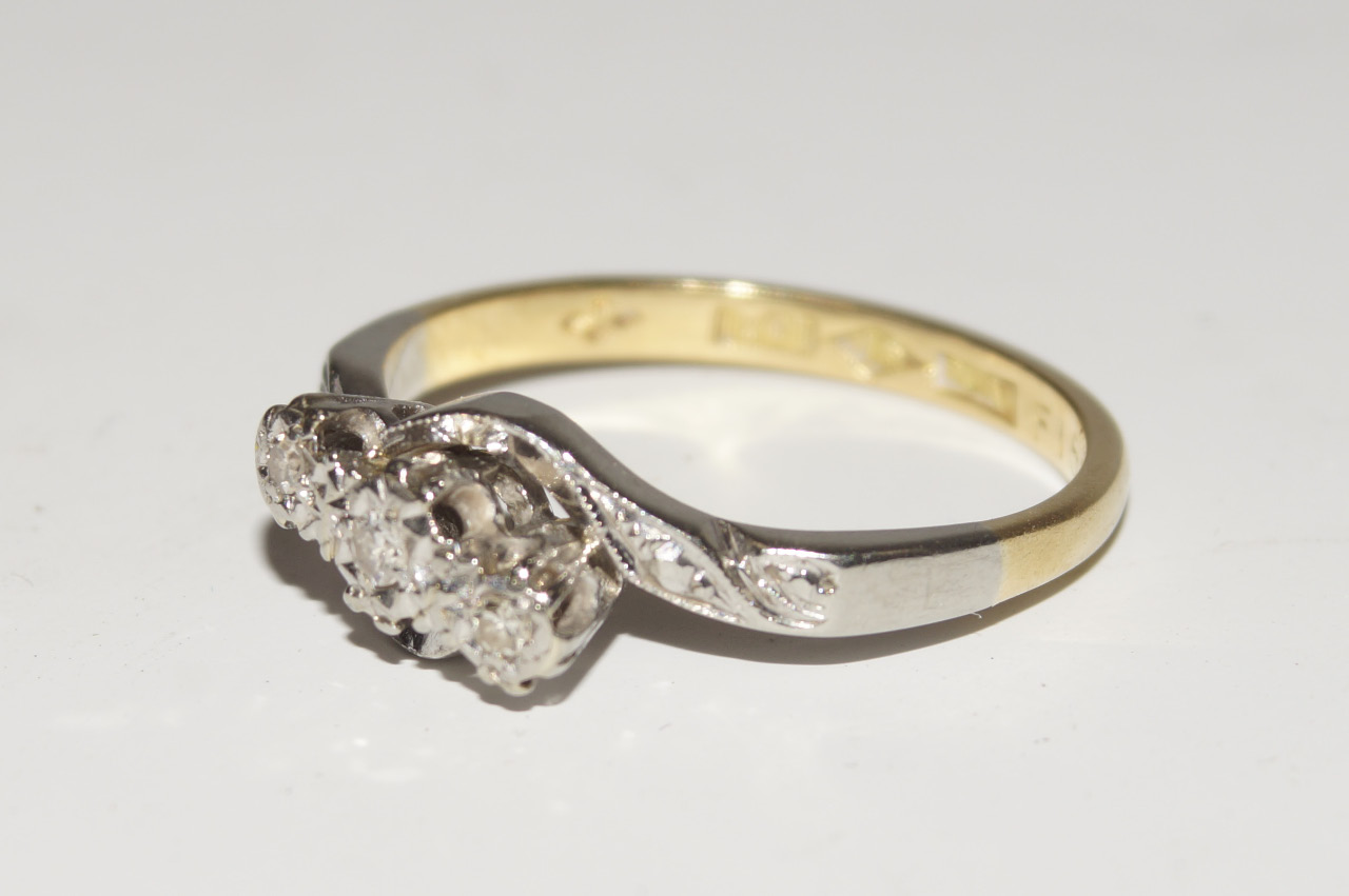 Appraisal: An ct gold and platinum three stone cross over ring