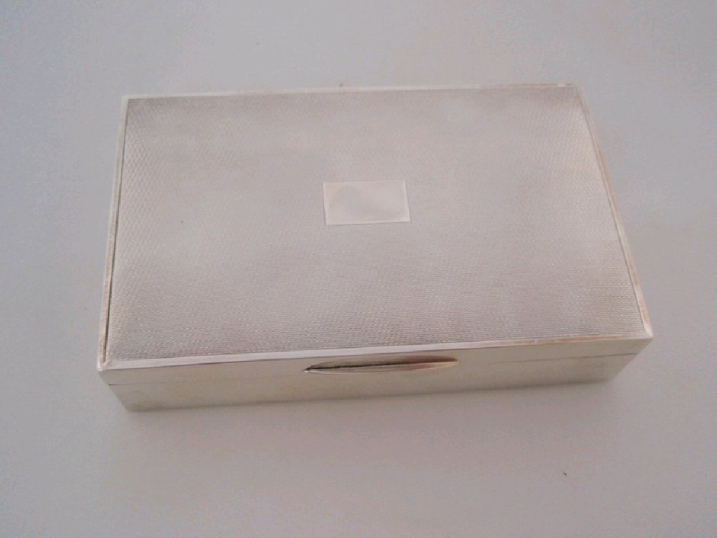 Appraisal: A silver covered engine turned cigarette box two compartments Birmingham