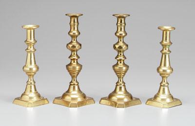 Appraisal: Two pairs brass push-up candlesticks one pair with beehive baluster