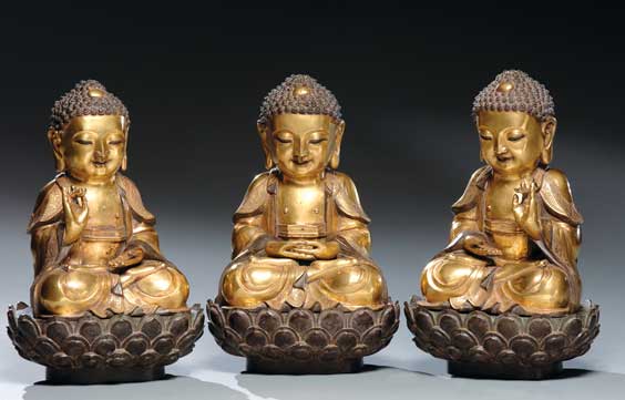 Appraisal: THREE GILT BRONZE BUDDHAS Group of three Chinese Ming-style gilt