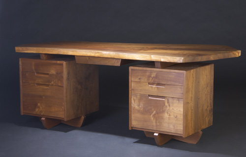 Appraisal: GEORGE NAKASHIMA Walnut double-pedestal desk with seven drawers under single-board