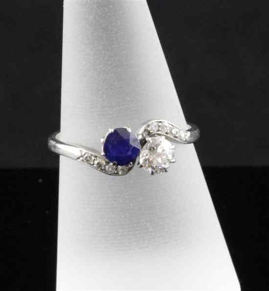 Appraisal: A platinum sapphire and diamond crossover ring with brilliant set