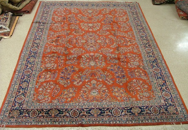 Appraisal: ORIENTAL INDO-SAROUK CARPET floral sprig design on red ground '