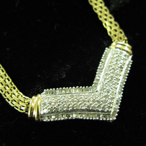 Appraisal: DIAMOND AND TEN KARAT GOLD NECKLACE having a V-form white