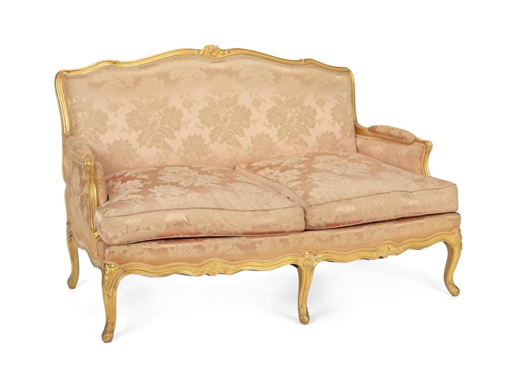 Appraisal: A French Louis XV-style giltwood settee with pink brocade upholstery