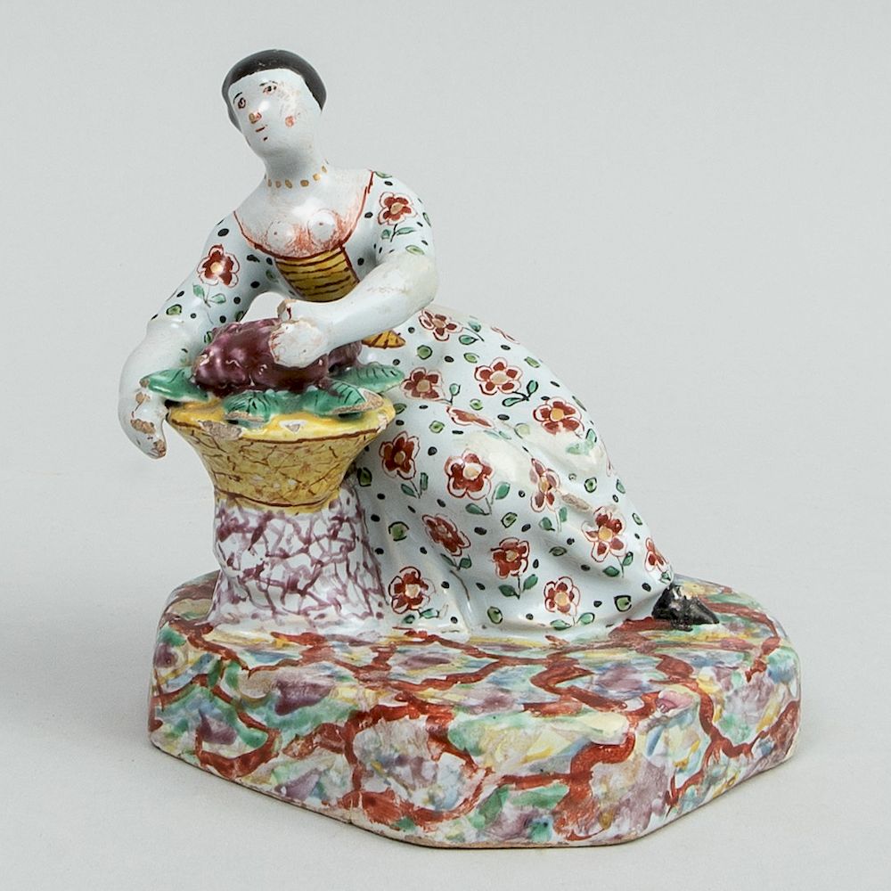 Appraisal: Dutch Polychrome Delft Figure of a Seated Woman with Basket