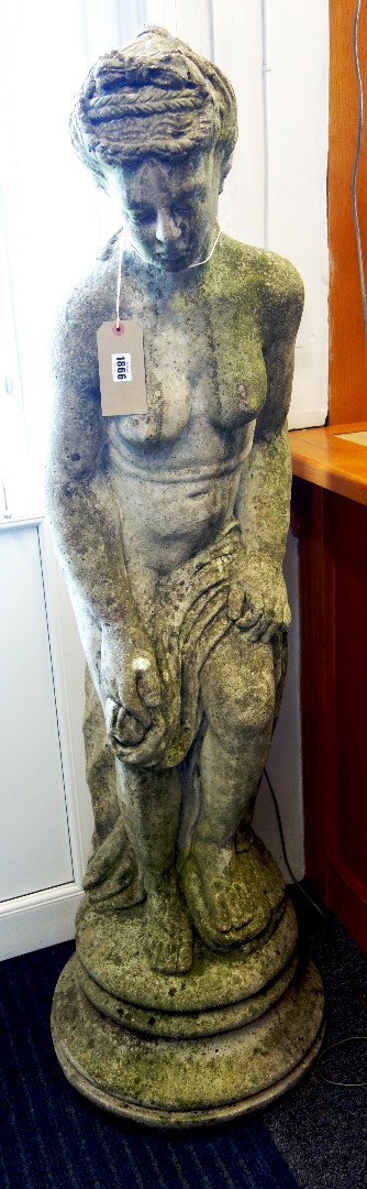 Appraisal: A reconstituted stone figure of a scantily robed lady on