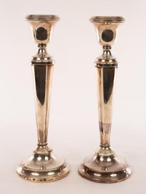 Appraisal: A pair of silver candlesticks Birmingham of hexagonal column form