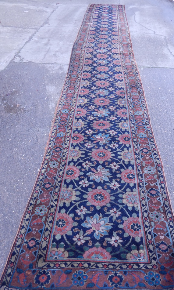 Appraisal: A Persian type runner with a design of flowers within