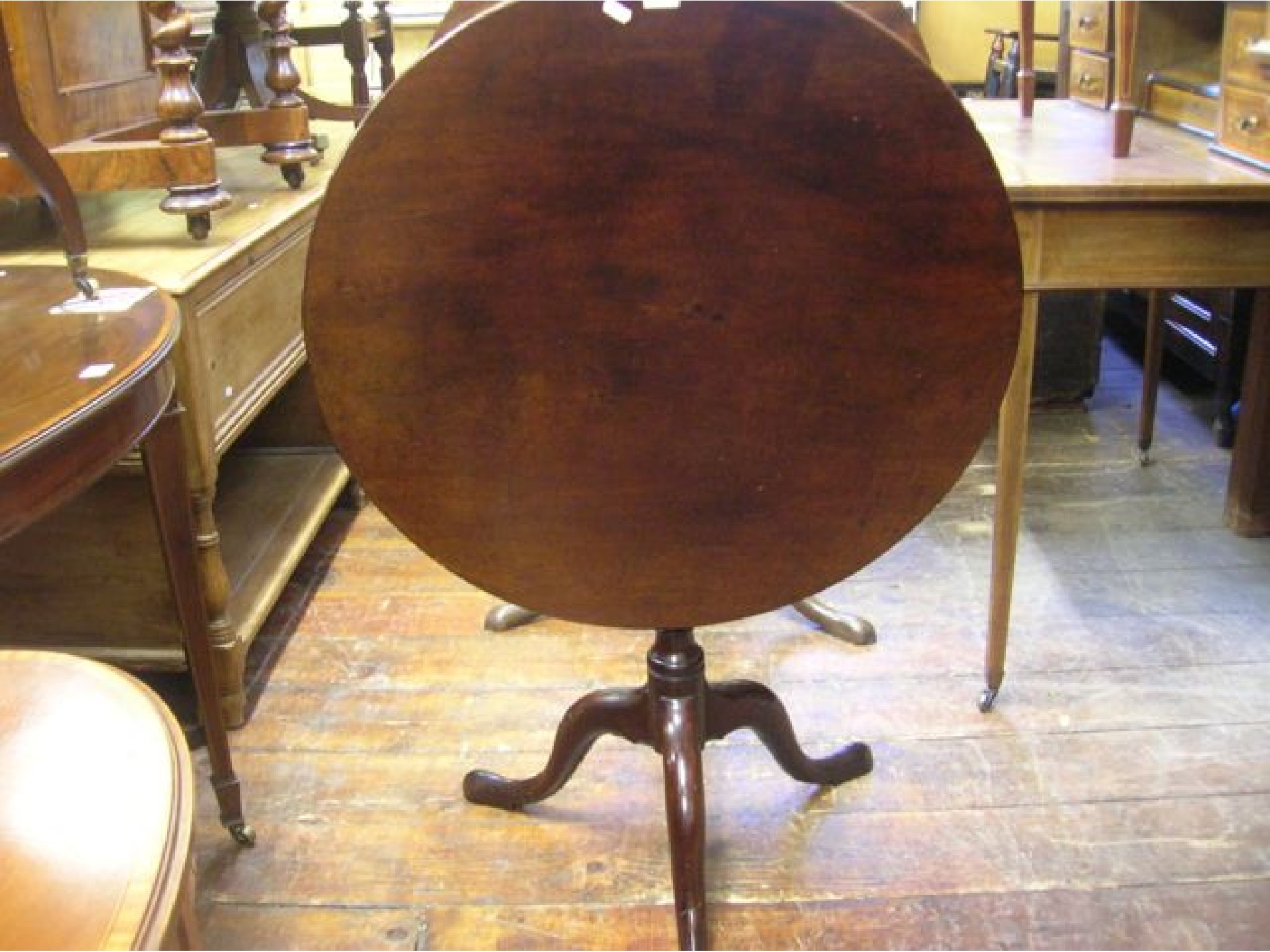 Appraisal: A Georgian mahogany snap top table with turned pillar and