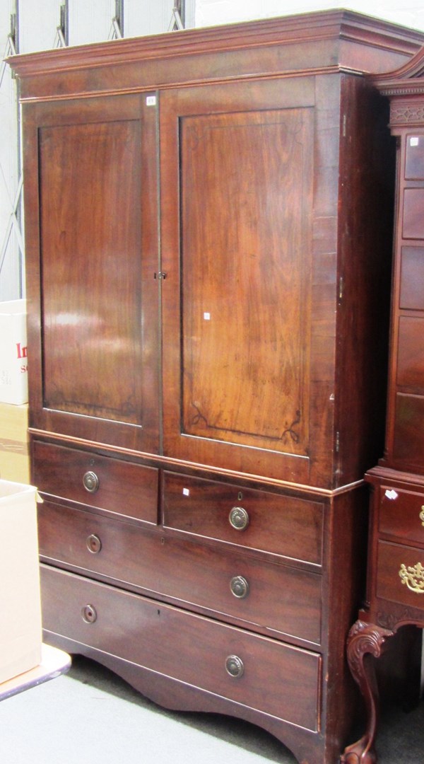 Appraisal: A George III mahogany linen press with a pair of