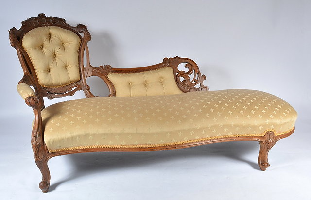 Appraisal: A Victorian walnut framed chaise longuewith carved back the pale