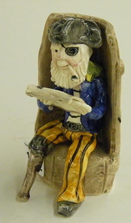 Appraisal: Alan Young pottery figure of a seated smuggler sat upon