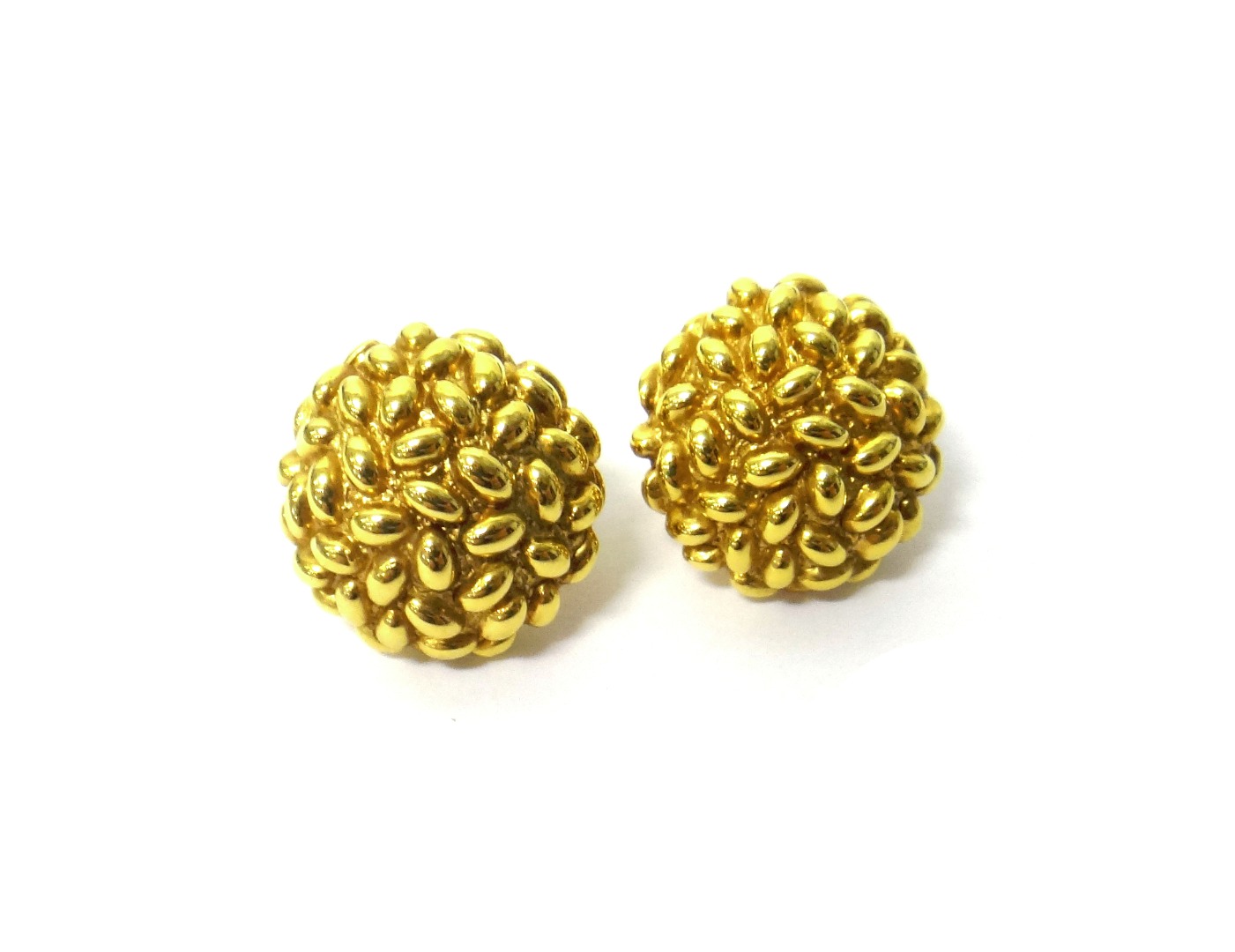 Appraisal: A pair of gold earclips each in a beaded hemispherical