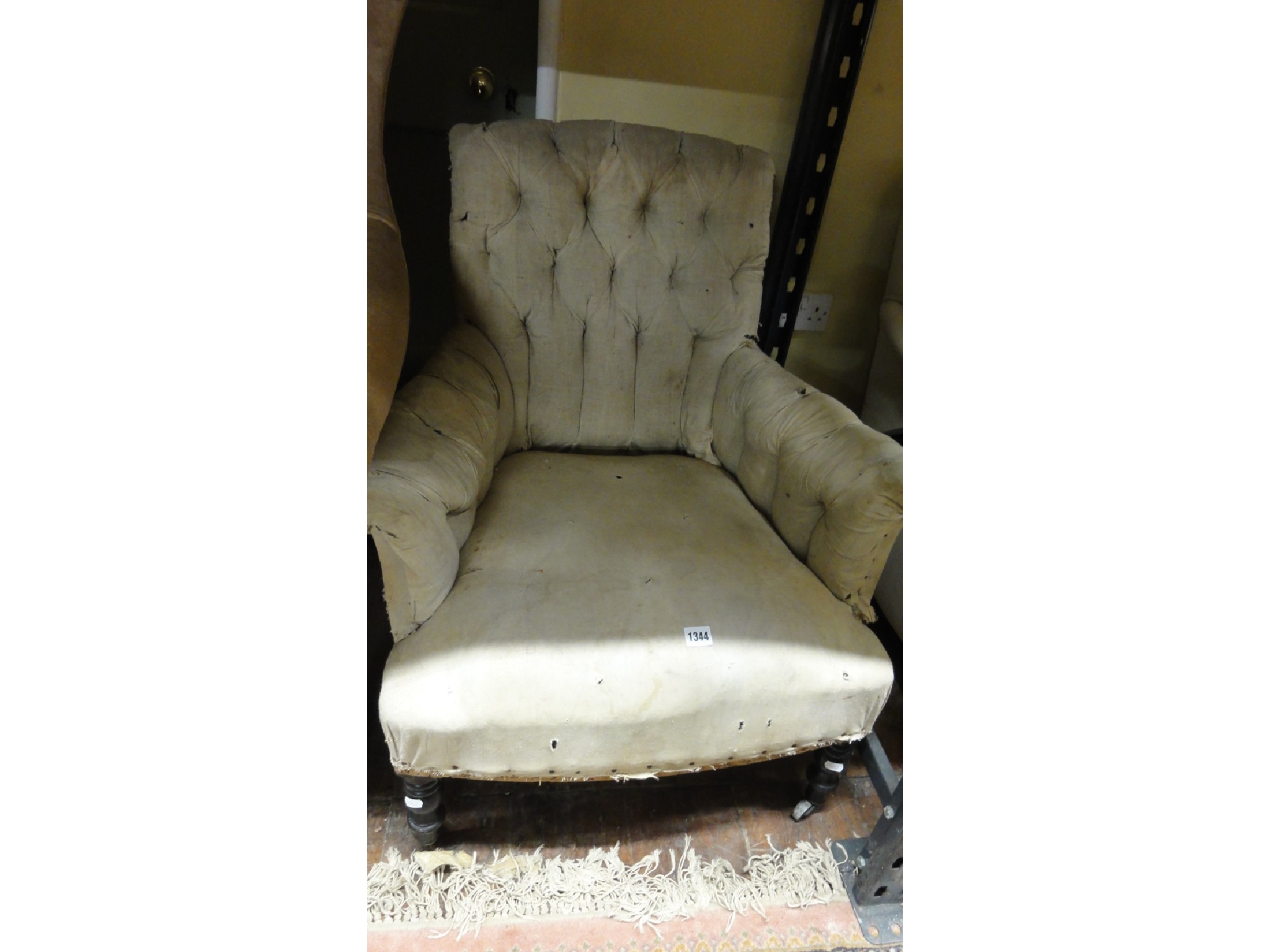 Appraisal: A low Victorian armchair with simply upholstered sprung seat swept