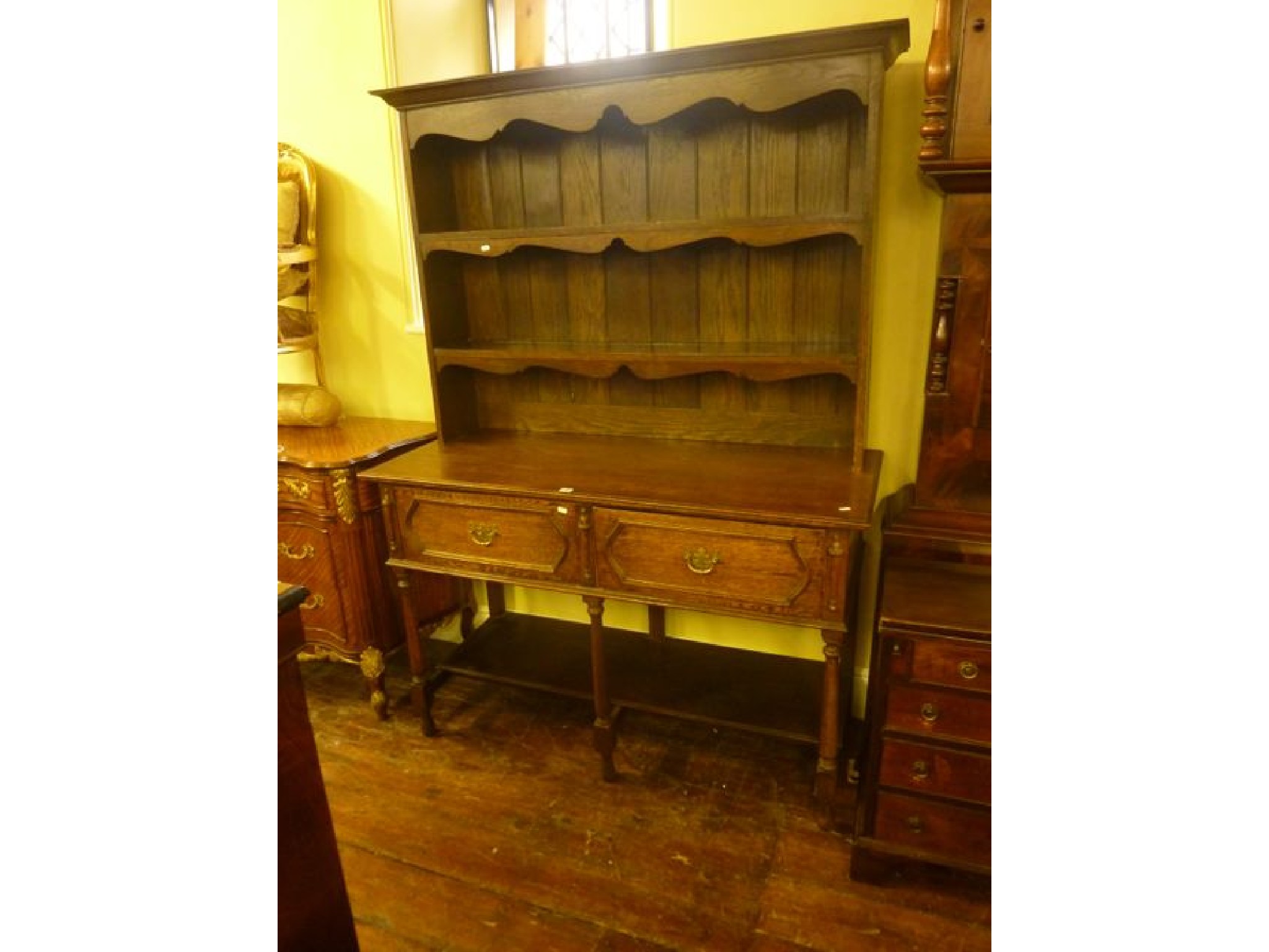 Appraisal: An Edwardian oak dresser in the Jacobean style enclosed by