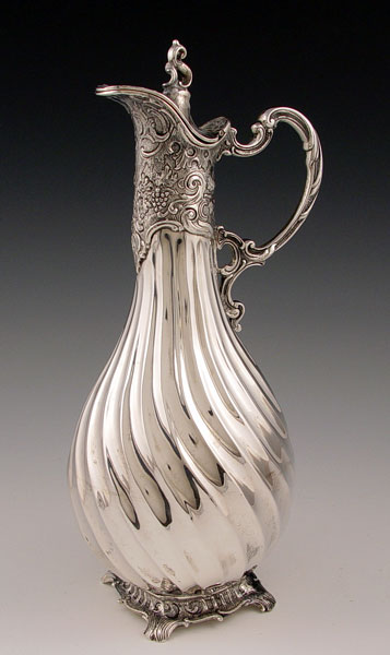 Appraisal: SIGNED SILVER CLARET JUG Swirl ribbed body with embossed floral