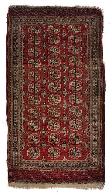 Appraisal: A TEKKE TURKOMAN WINE GROUND RUG with three rows of