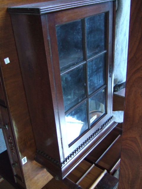 Appraisal: A small th century mahogany hanging cupboard the dentil cornice