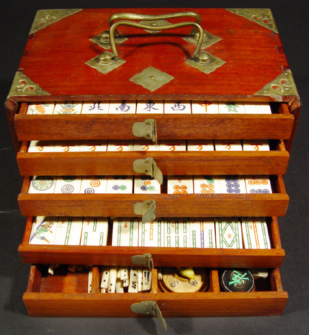 Appraisal: Set of oriental bone mahjong pieces in a brass mounted