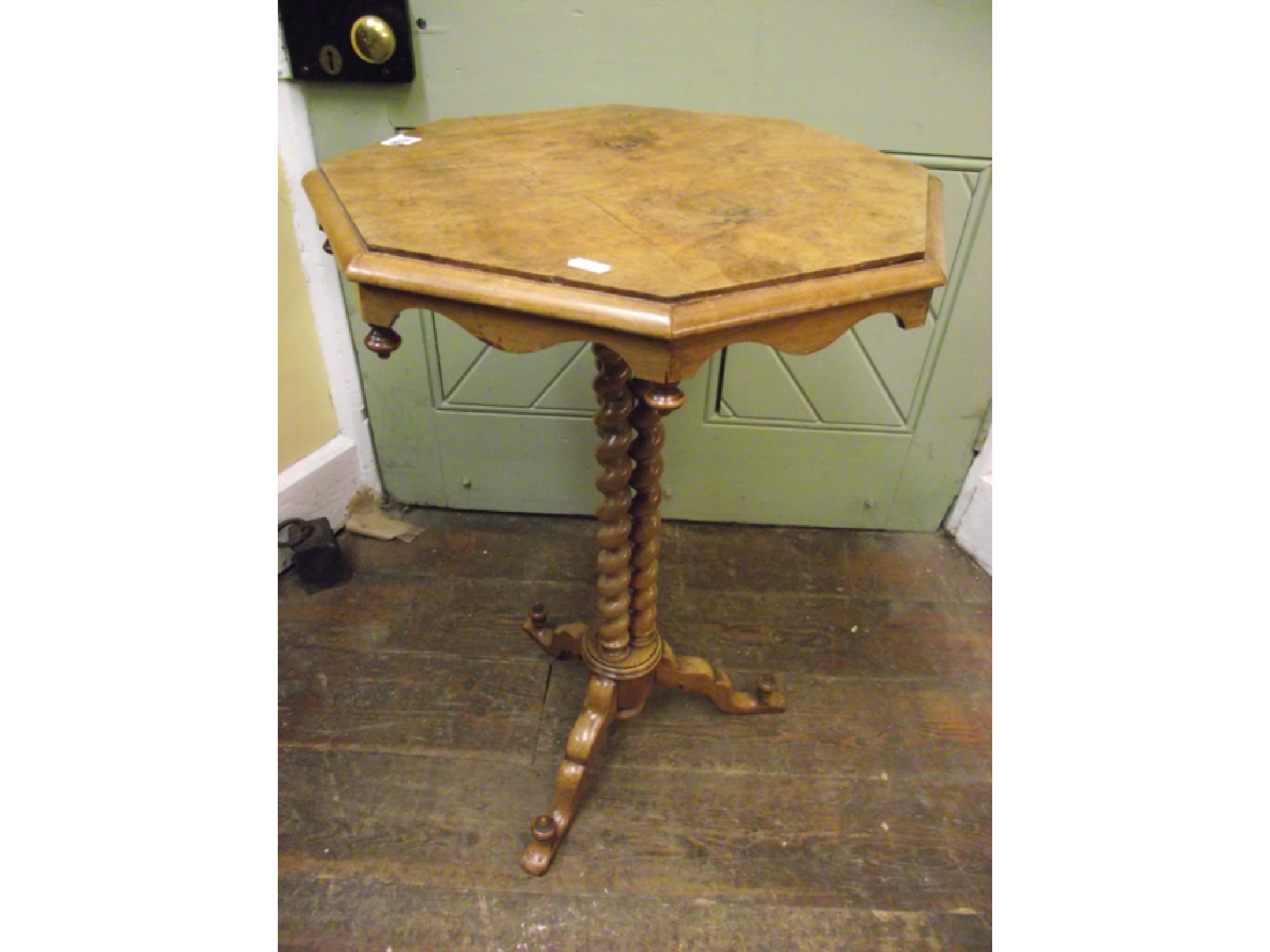 Appraisal: A pale walnut occasional table the octagonal top raised on