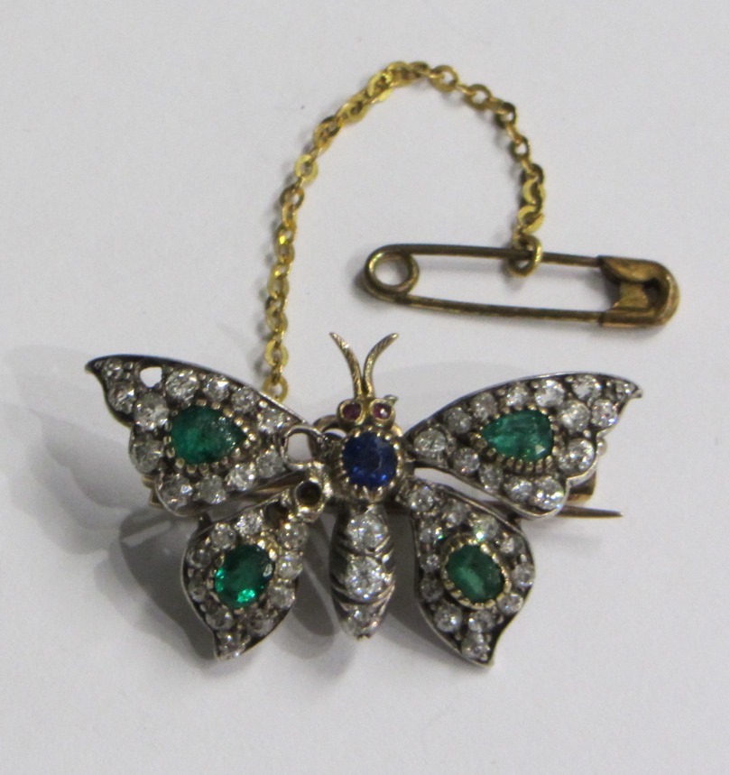 Appraisal: A diamond emerald and sapphire set brooch designed as a