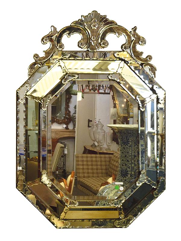 Appraisal: A VENETIAN STYLE CUSHION FRONT WALL MIRROR the canted rectangular