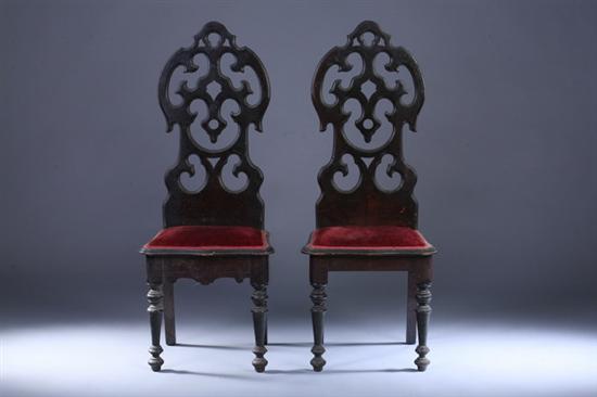 Appraisal: PAIR GOTHIC STYLE WALNUT HALL CHAIRS th century with burgundy