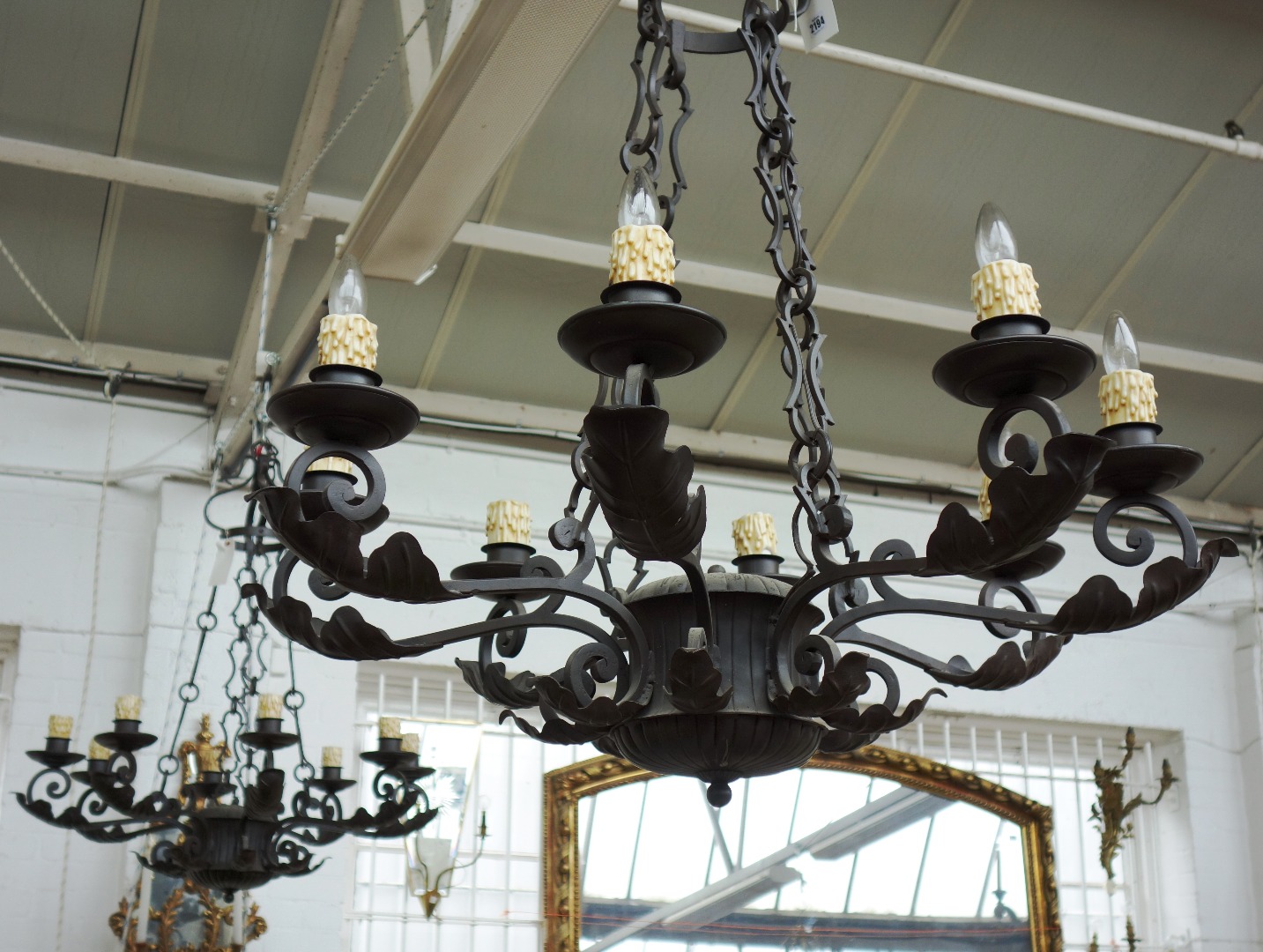 Appraisal: A pair of English wrought iron eight light chandeliers late