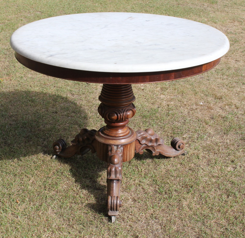 Appraisal: A Victorian mahogany centre table with carved and jewelled pillar