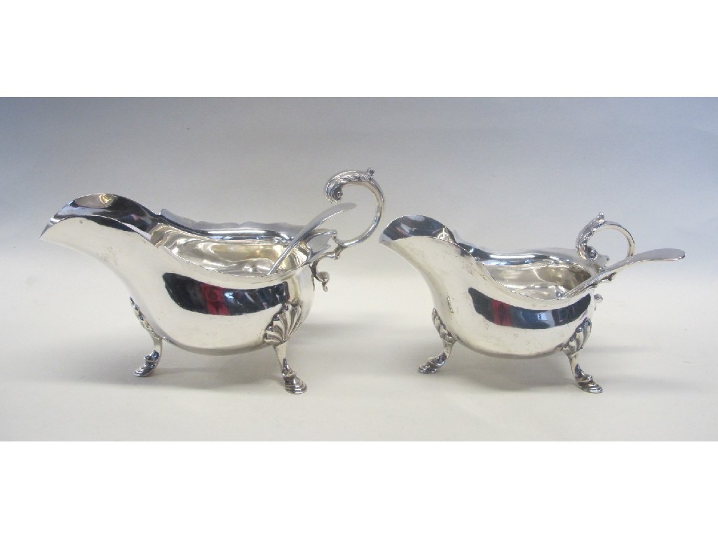 Appraisal: Two silver sauceboats on hoof feet and two sauce ladles