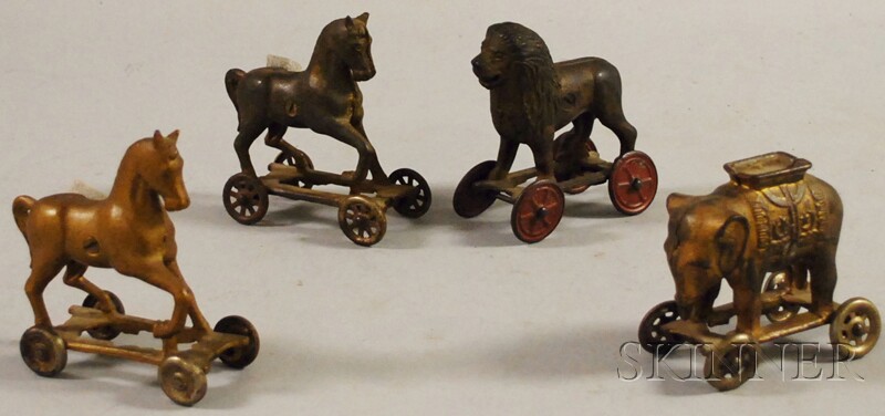 Appraisal: Four Painted Cast Iron Animal Figural Still Banks on Wheels