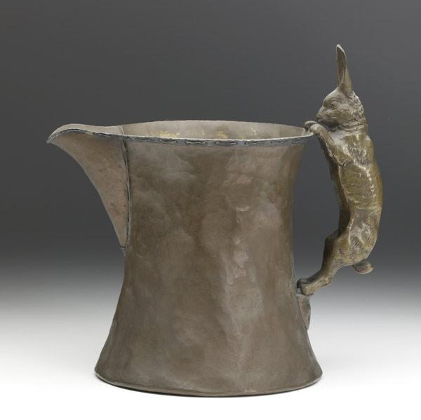 Appraisal: JOSEPH HEINRICHSHammered copper pitcher bronze rabbit handle and stitched silver