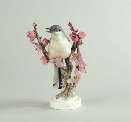 Appraisal: ROYAL WORCESTER PORCELAIN MOCKINGBIRD WITH PEACH BLOSSOM MODELED BY DOROTHY